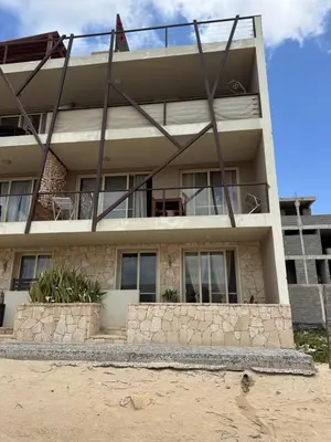 a house on the beach with a building at CA MINHA Praia Estoril Sal Rei Boa Vista in Sal Rei