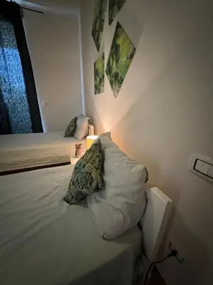 a bedroom with a bed with a pillow and a lamp at CA MINHA Praia Estoril Sal Rei Boa Vista in Sal Rei
