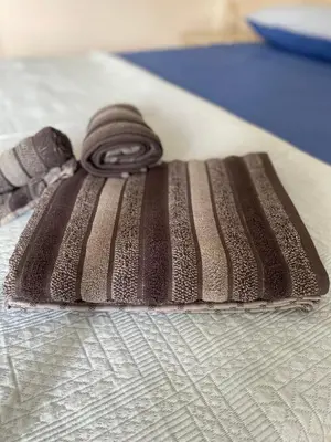 a brown and white wrapped object on a bed at Sea view Ka Paola, Praia Cabral, Boa Vista, FREE WI-FI in Sal Rei