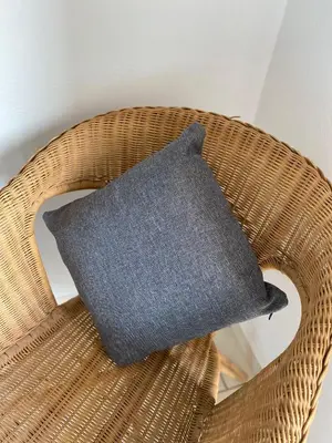a black pillow sitting on a wicker chair at Sea view Ka Paola, Praia Cabral, Boa Vista, FREE WI-FI in Sal Rei