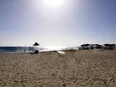a sandy beach with umbrellas and the ocean at Sal Service beachside angulo in Santa Maria
