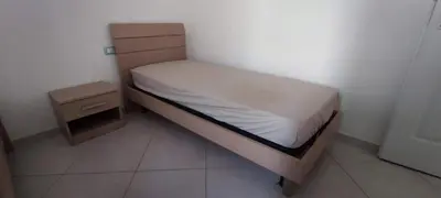 a small bedroom with a bed and a night stand at Sal Service beachside angulo in Santa Maria