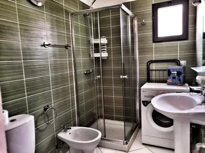 a bathroom with a shower and a toilet and a sink at Sal Service beachside angulo in Santa Maria
