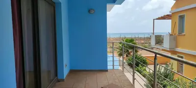 a balcony with a blue wall and a view of the ocean at Sal Service beachside angulo in Santa Maria