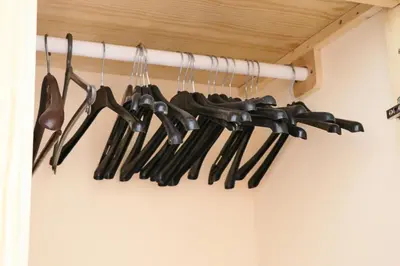 a bunch of cooking utensils hanging on a rack at Apartamento Preguiça in Espargos