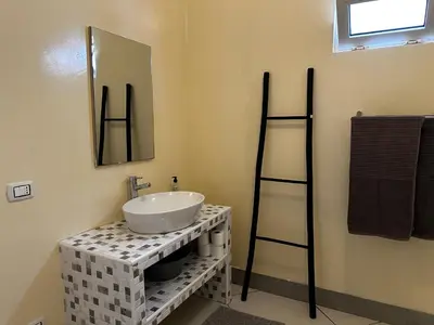 a bathroom with a sink and a mirror at Casa Tud Dret - By Bobbywashere in Sal Rei