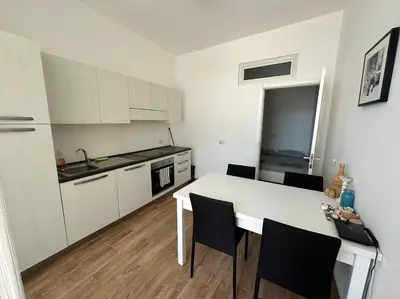 a kitchen with a white table and chairs in a room at Casa Tud Dret - By Bobbywashere in Sal Rei