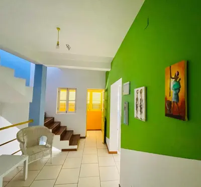 a hallway with a green wall and a staircase at La Residencia in Mindelo