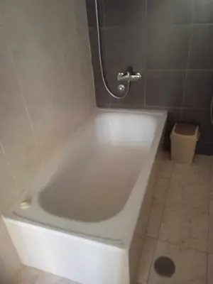 a white bath tub in a bathroom with a toilet at Casa Amarela in Ponta do Sol
