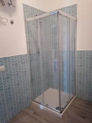 a shower with glass doors in a bathroom at SGC Boa Vista Apartments in Sal Rei