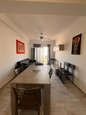 a kitchen and living room with a table and chairs at SGC Boa Vista Apartments in Sal Rei