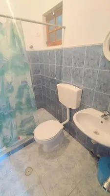 a bathroom with a toilet and a sink at Pensão Alcinda Bettencourt 50 meters to the Beachfront in Santa Maria