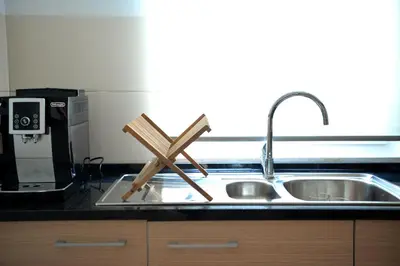 a kitchen sink with a wooden cross on it at Guesthouse Le Châtelain in Santa Maria