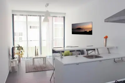 a white room with a desk and a table at Morabezahome in Mindelo