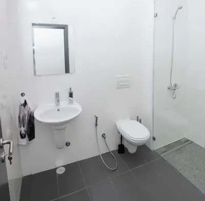 a white bathroom with a sink and a toilet at Morabezahome in Mindelo