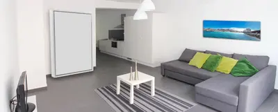 a living room with a couch and a table at Morabezahome in Mindelo