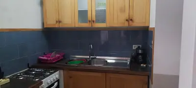 a kitchen with a sink and a stove at Casa Verde in Mindelo