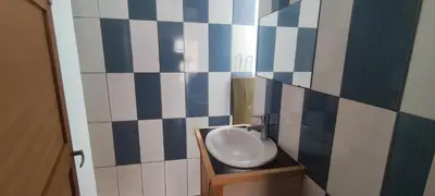 a bathroom with a sink and a blue and white tiled wall at Casa Verde in Mindelo