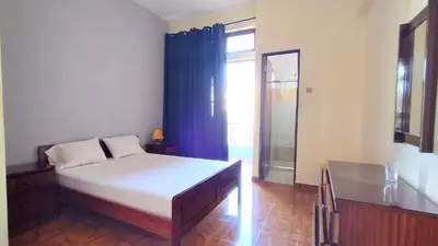 a bedroom with a bed and a large window at Residencial Amarante in Mindelo