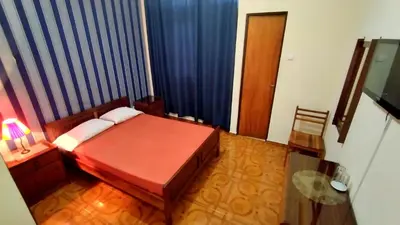 a small bedroom with a bed and a table at Residencial Amarante in Mindelo