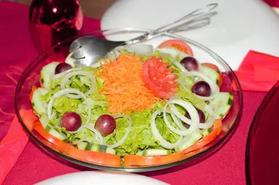 a salad in a glass bowl on a table at Dunas De Areia Preta in Ribeira da Prata