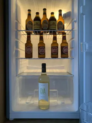 a refrigerator filled with lots of bottles of beer at Dunas De Areia Preta in Ribeira da Prata