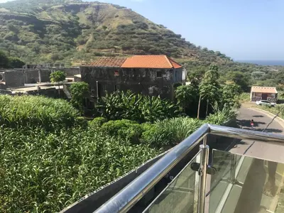 a view from the balcony of a house with a mountain at Dunas De Areia Preta in Ribeira da Prata