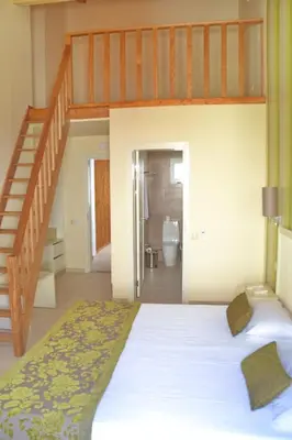 a bedroom with a bunk bed with a staircase at Ouril Hotel Julia in Santa Maria