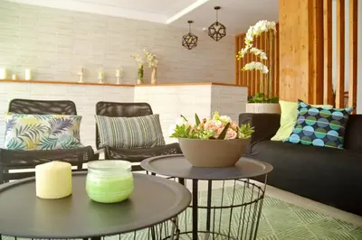 a living room with two tables and chairs at Ouril Hotel Julia in Santa Maria