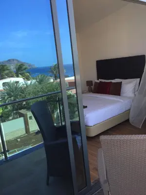 a bedroom with a bed and a view of the ocean at Lali's House in Tarrafal