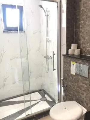 a shower stall with a toilet in a bathroom at Lali's House in Tarrafal