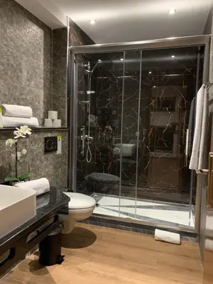 a bathroom with a shower and a toilet and a sink at Lali's House in Tarrafal