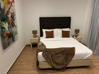 a bedroom with a large bed with a blanket on it at Lali's House in Tarrafal