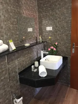 a bathroom with a sink and a mirror at Lali's House in Tarrafal