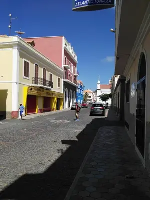 a child walking down a street in a city at Residencial Casa da Luz in Mindelo