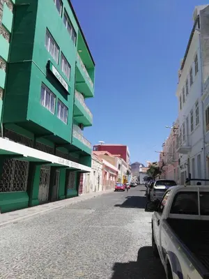 a green building on the side of a street at Residencial Casa da Luz in Mindelo