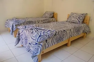 two beds sitting next to each other in a room at casa xoxo in Ribeira Grande