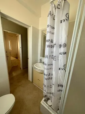 a bathroom with a toilet and a shower curtain at sea View Nautilus free wi-fi Sal Rei in Sal Rei