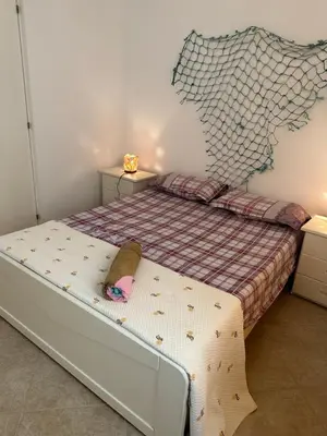 a bedroom with a bed with a foot board and a bed at sea View Nautilus free wi-fi Sal Rei in Sal Rei