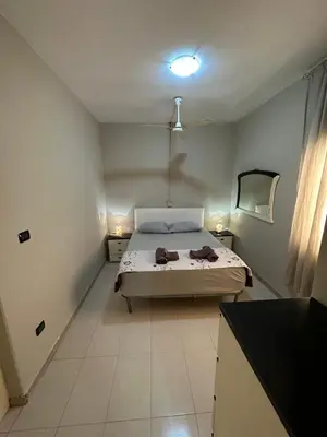 a small bedroom with a bed and a mirror at sea View Nautilus free wi-fi Sal Rei in Sal Rei