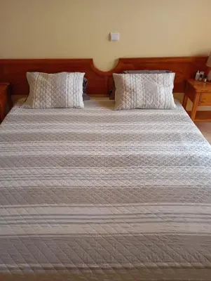 a large bed with two pillows on top of it at Solmar apartment in Beirona