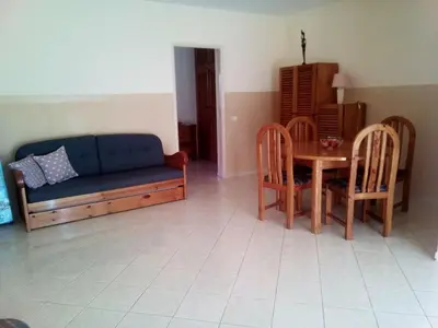 a living room with a couch and a table and chairs at Solmar apartment in Beirona