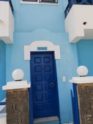 a blue door in the middle of a building at Casa Azul Apt Two Rua da Morna up from Mercado Municipal 4111 in Santa Maria