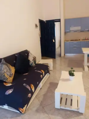 a living room with a couch and a table at Casa Azul Apt Two Rua da Morna up from Mercado Municipal 4111 in Santa Maria