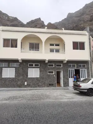 a building with a car parked in front of it at POUSADA O RECANTO in Paul