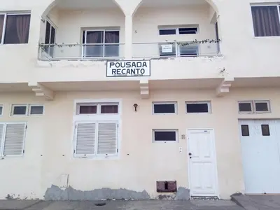 a white building with a sign that reads pueblula regina at POUSADA O RECANTO in Paul