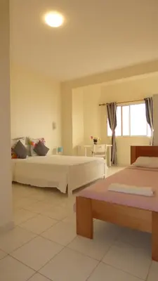 a hotel room with two beds and a window at POUSADA O RECANTO in Paul