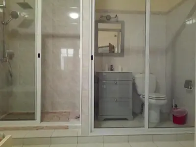 a bathroom with a toilet and a glass shower at POUSADA O RECANTO in Paul