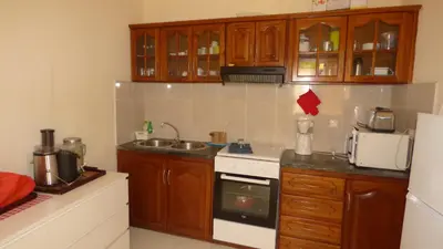 a kitchen with a sink and a stove top oven at POUSADA O RECANTO in Paul