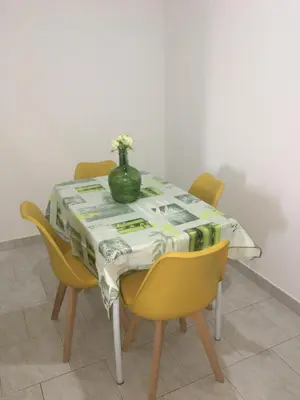 a table with a green vase on top of it at Apartamento Llana in Santa Maria